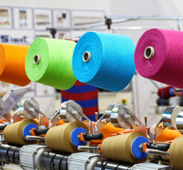 How does fancy yarn enhance the uniqueness and creative design of textiles?